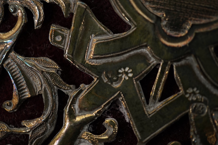 A white metal mounted rectangular desk folder, with beaded borders and pierced and decorated with scrolling foliage, birds and oval panels depicting figures at various pursuits, stamped '13', 30.6cm. Condition - poor to